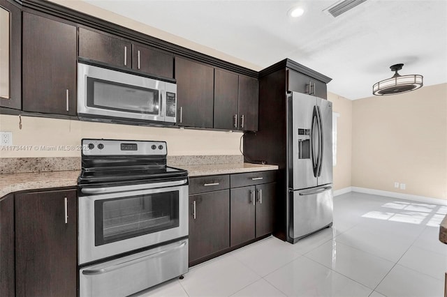 kitchen with light tile patterned flooring, appliances with stainless steel finishes, and dark brown cabinets