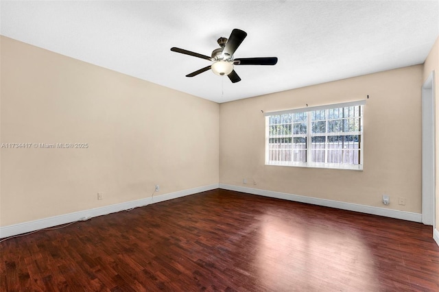 spare room featuring dark hardwood / wood-style flooring and ceiling fan