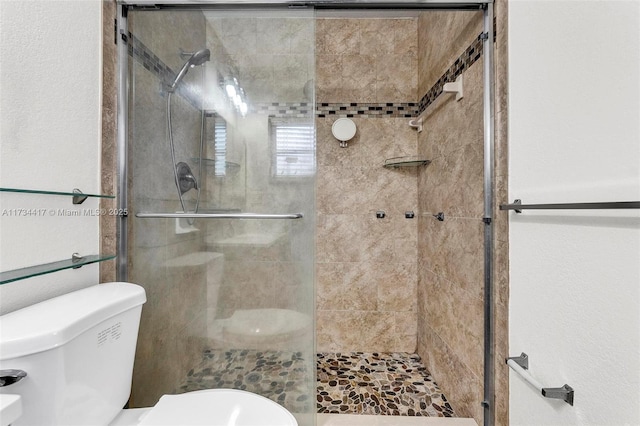 bathroom featuring an enclosed shower and toilet