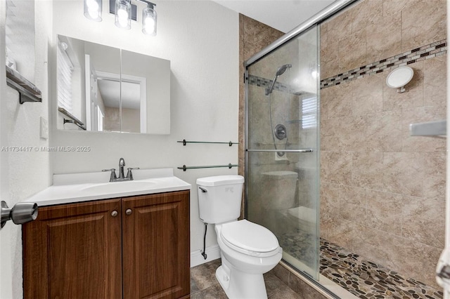 bathroom with vanity, a shower with shower door, and toilet