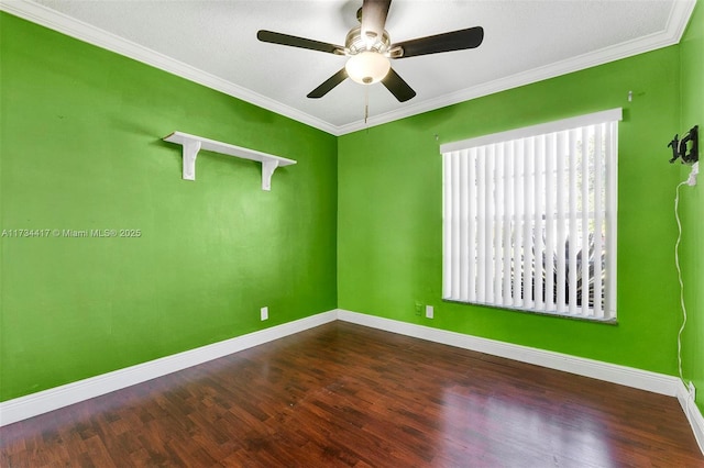 spare room with ornamental molding, dark hardwood / wood-style floors, and ceiling fan