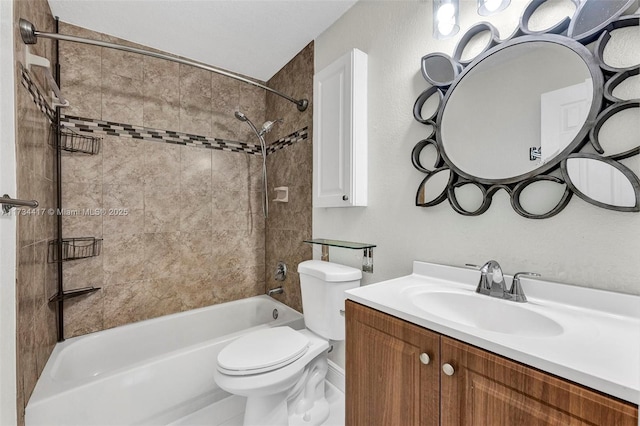 full bathroom featuring tiled shower / bath, vanity, and toilet