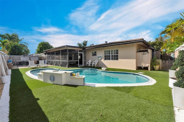 view of pool with a sunroom and a lawn