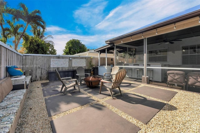 view of patio with ceiling fan and a fire pit