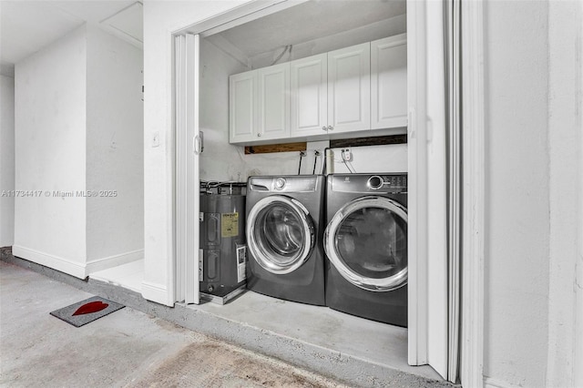 laundry room with water heater, cabinets, and washer and dryer