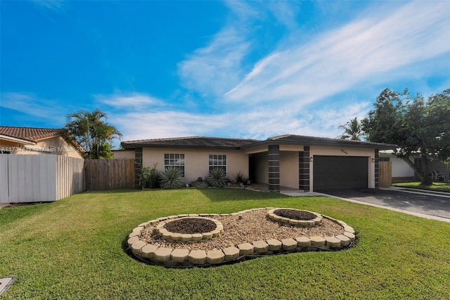 single story home featuring a garage and a front yard