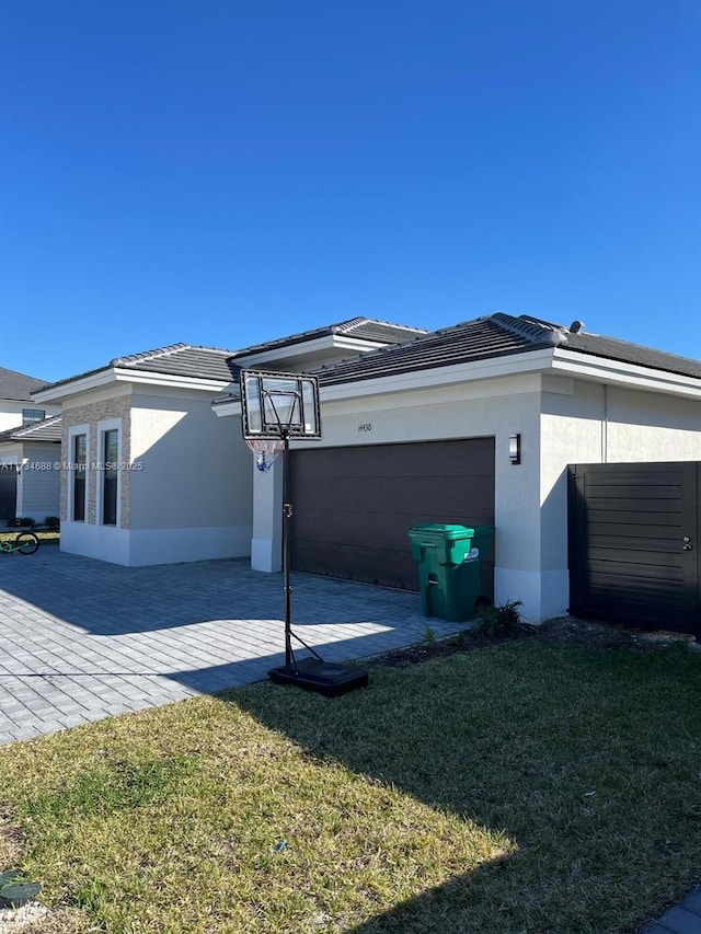 view of home's exterior featuring a garage and a lawn