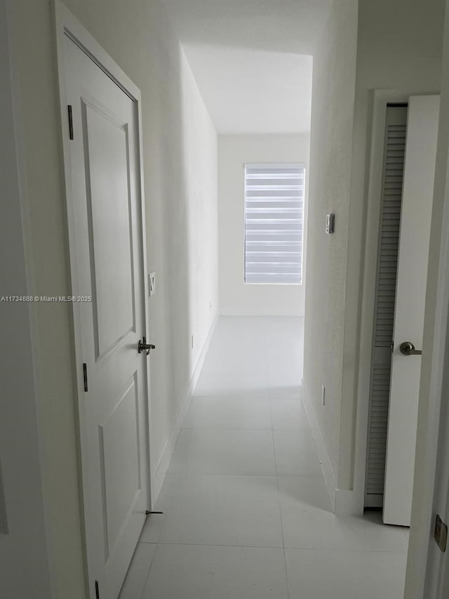 hall featuring light tile patterned flooring