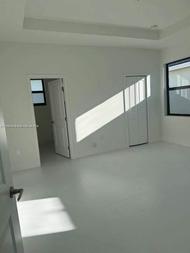 unfurnished room with a raised ceiling