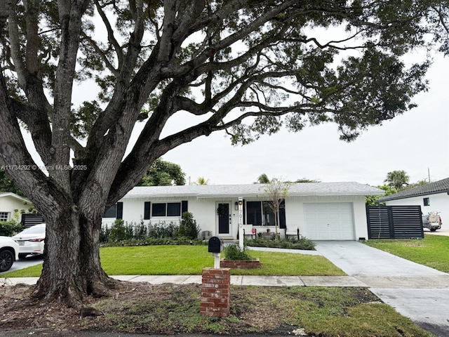 single story home with a garage and a front lawn