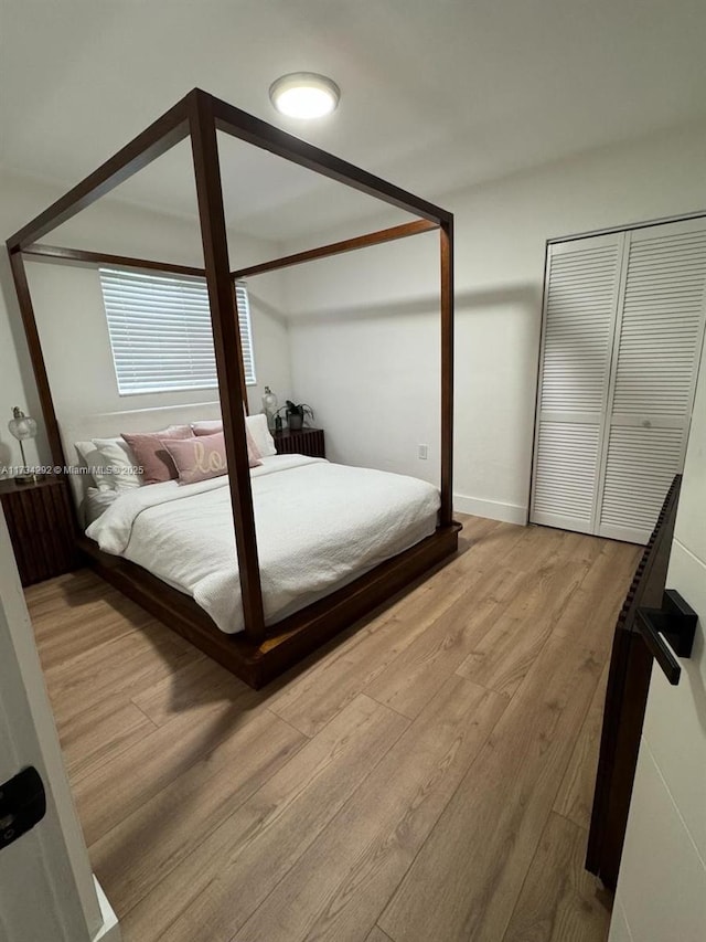 bedroom with radiator heating unit and light hardwood / wood-style floors