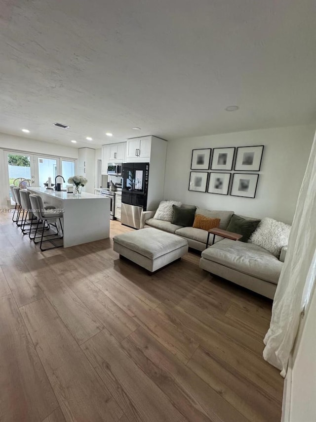 living room with light hardwood / wood-style flooring