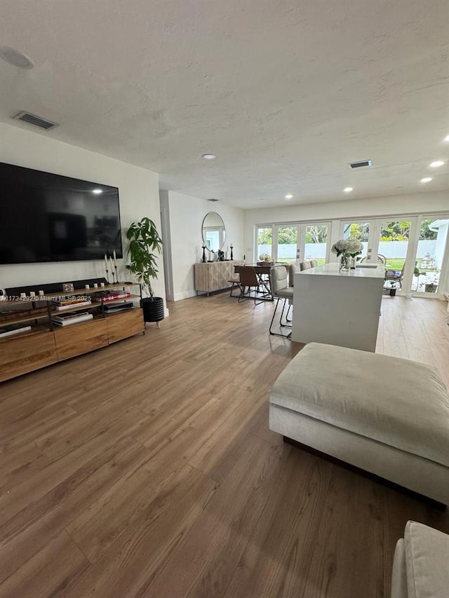 living room featuring french doors and hardwood / wood-style flooring