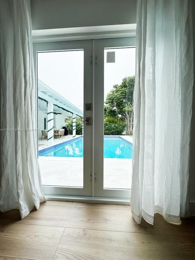 doorway to outside featuring french doors and light hardwood / wood-style floors