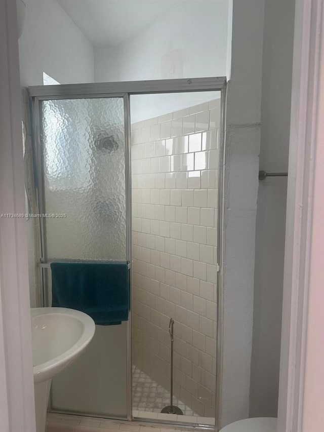 bathroom featuring an enclosed shower and toilet