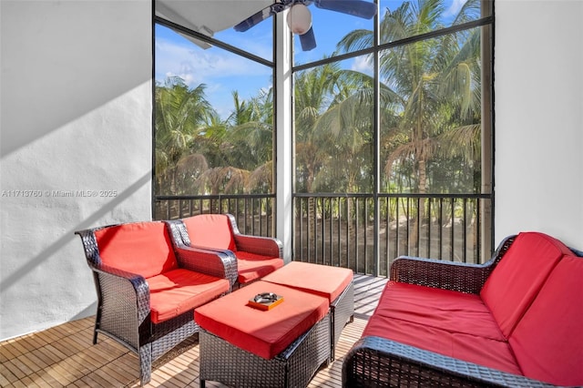 sunroom / solarium with a ceiling fan and a healthy amount of sunlight