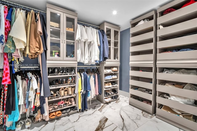 spacious closet with marble finish floor