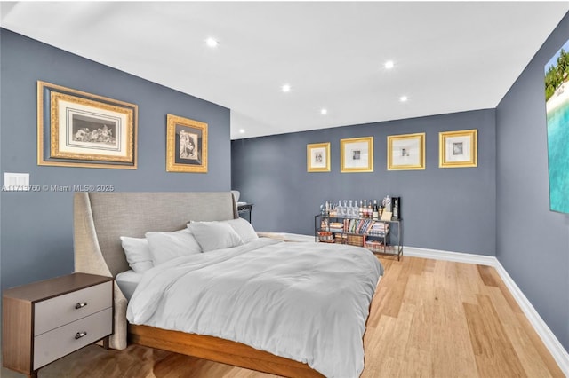 bedroom featuring recessed lighting, wood finished floors, and baseboards