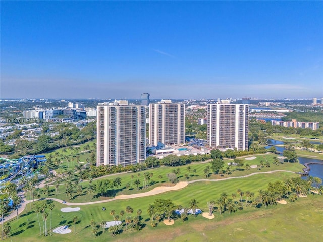 birds eye view of property with a city view, golf course view, and a water view