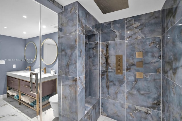 bathroom with toilet, marble finish floor, and vanity