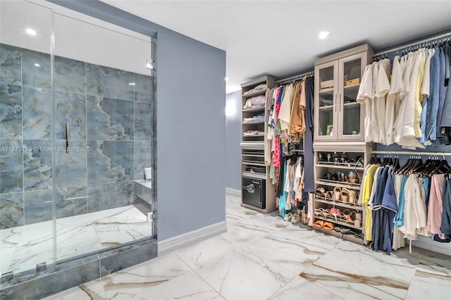 spacious closet featuring marble finish floor