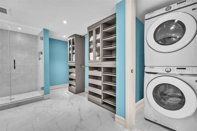 laundry room featuring visible vents, laundry area, recessed lighting, stacked washer and clothes dryer, and marble finish floor