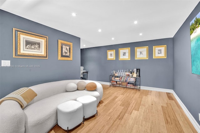 sitting room featuring recessed lighting, wood finished floors, and baseboards