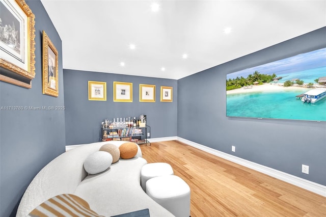 living area featuring recessed lighting, baseboards, and wood finished floors