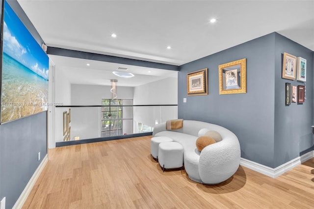 sitting room featuring recessed lighting, baseboards, and wood finished floors