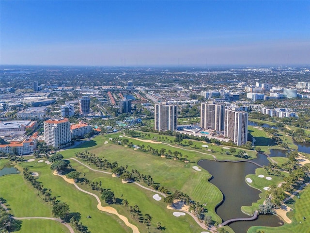 bird's eye view featuring a water view, view of golf course, and a view of city