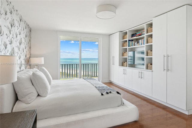 bedroom featuring hardwood / wood-style flooring and access to outside