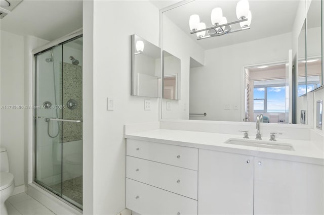 bathroom with vanity, toilet, an enclosed shower, and tile patterned flooring