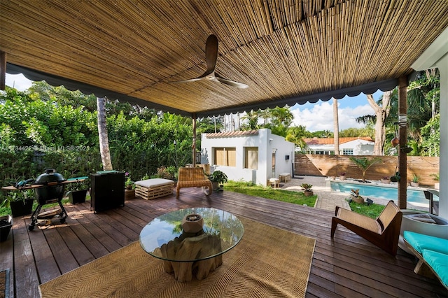 deck featuring an outdoor structure and ceiling fan