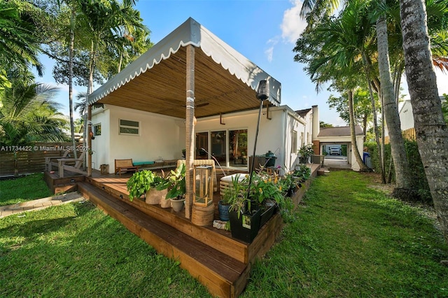 rear view of property with a yard