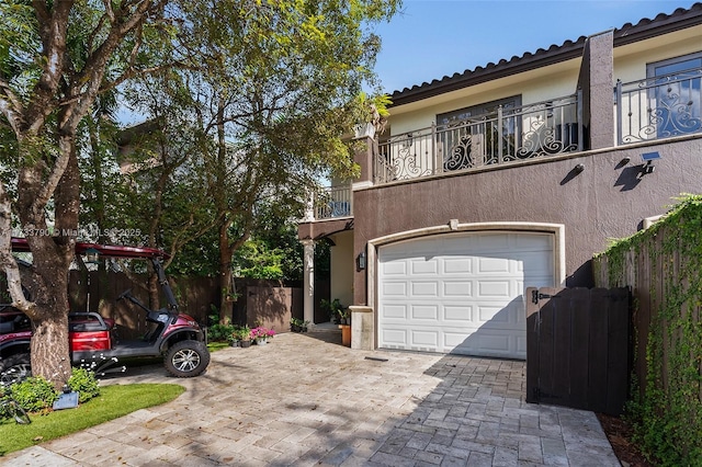 view of front of house with a balcony and a garage