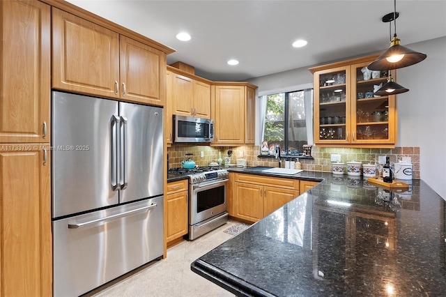 kitchen featuring appliances with stainless steel finishes, decorative light fixtures, sink, and decorative backsplash