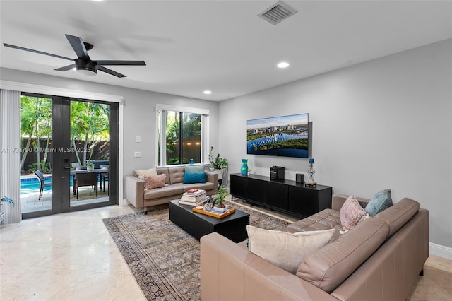 living room featuring french doors and ceiling fan