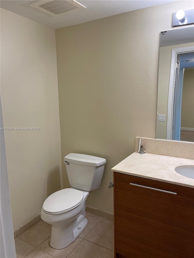 bathroom with tile patterned floors, toilet, and vanity