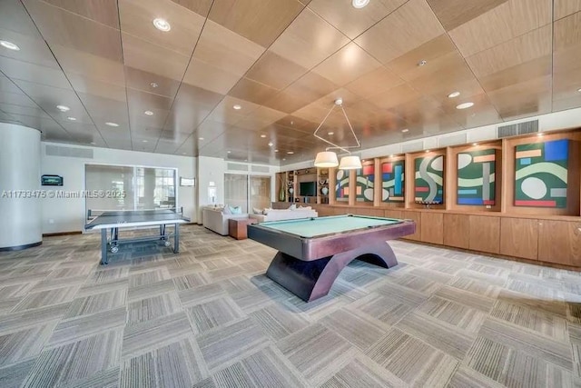 game room with billiards, light colored carpet, and water heater