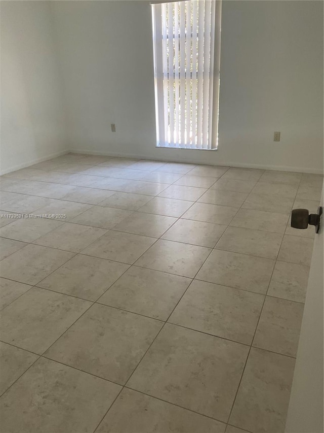 201 178th Dr Unit 309, Sunny Isles Beach, FL 33160 - tiled spare room with baseboards