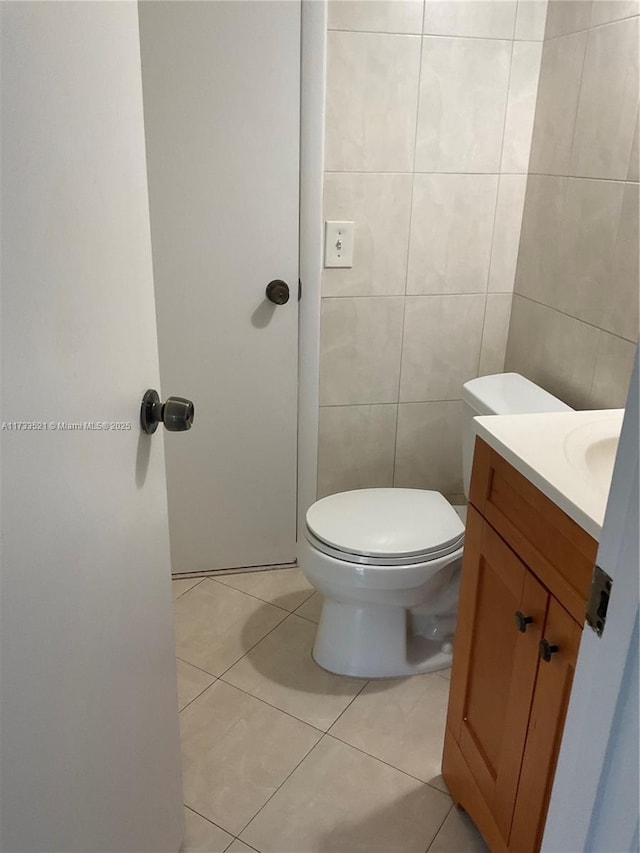 201 178th Dr Unit 309, Sunny Isles Beach, FL 33160 - bathroom featuring toilet, vanity, tile patterned flooring, and tile walls