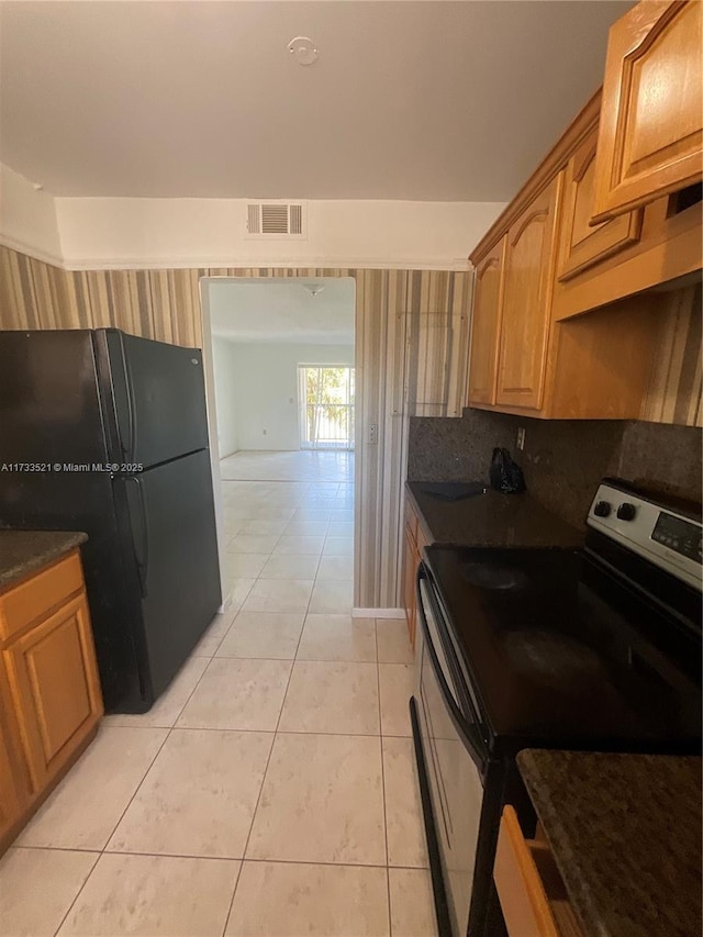 201 178th Dr Unit 309, Sunny Isles Beach, FL 33160 - kitchen with freestanding refrigerator, light tile patterned floors, visible vents, dark countertops, and stainless steel electric range