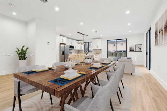 dining space featuring light wood-type flooring