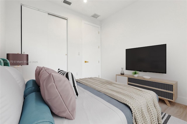 bedroom featuring wood-type flooring and a closet