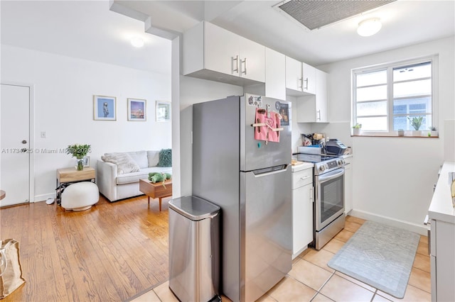 kitchen featuring white cabinetry and appliances with stainless steel finishes