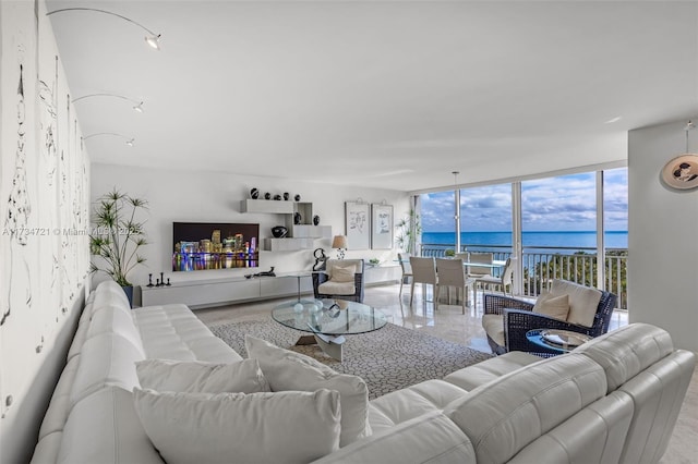 living room featuring a water view and floor to ceiling windows