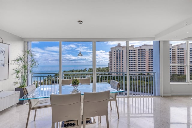 sunroom featuring a water view