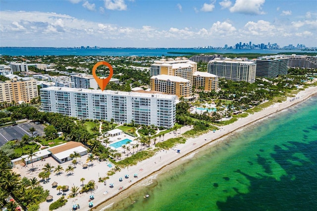 birds eye view of property with a water view and a view of the beach