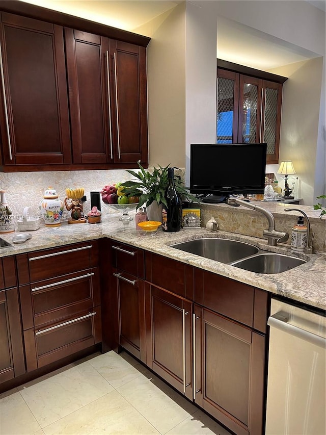 kitchen featuring sink, dishwasher, backsplash, light stone countertops, and light tile patterned flooring