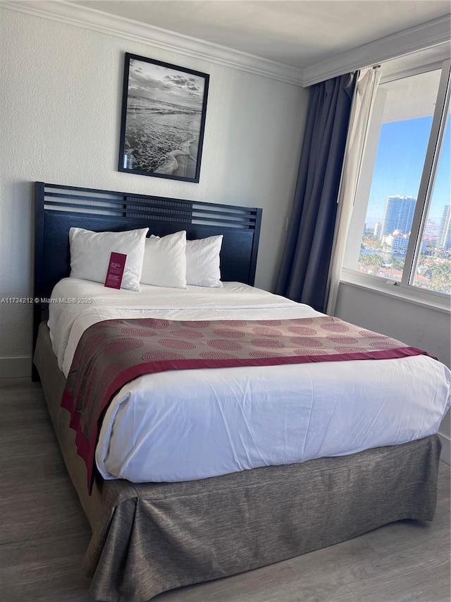 bedroom featuring hardwood / wood-style flooring and ornamental molding